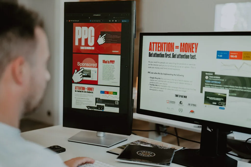 JUGGERNAUT marketing workspace with campaign content on two monitors
